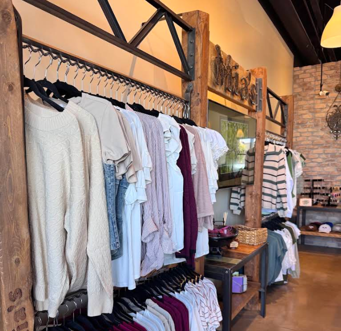 Racks of tops, sweaters and denim inside Mia's Boutique